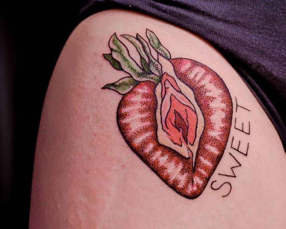 tattoo colored strawberry in the form of a vagina