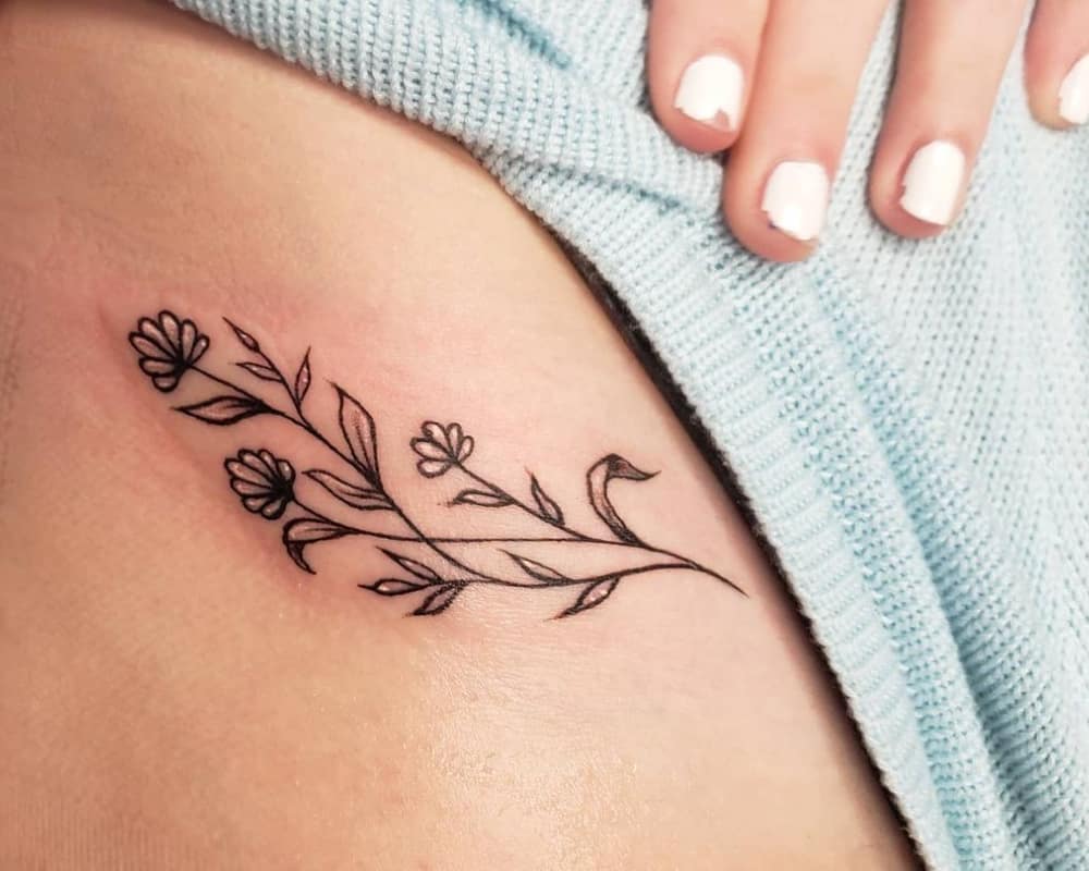 tattoo in the form of a branch with flowers