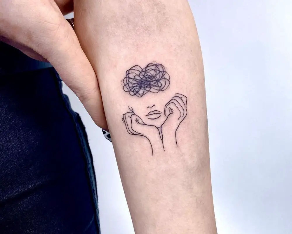 tattoo in the form of a silhouette of a head propped up by hands with a tangled ball in its head