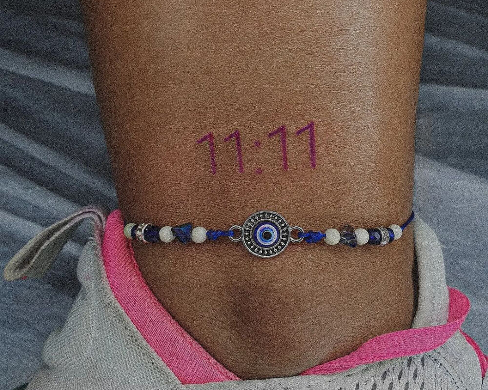tattoo of 11:11 on the leg