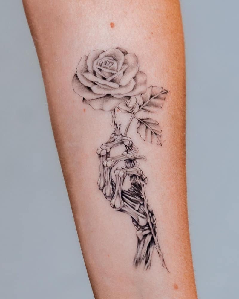 tattoo of a dead hand holding a rose