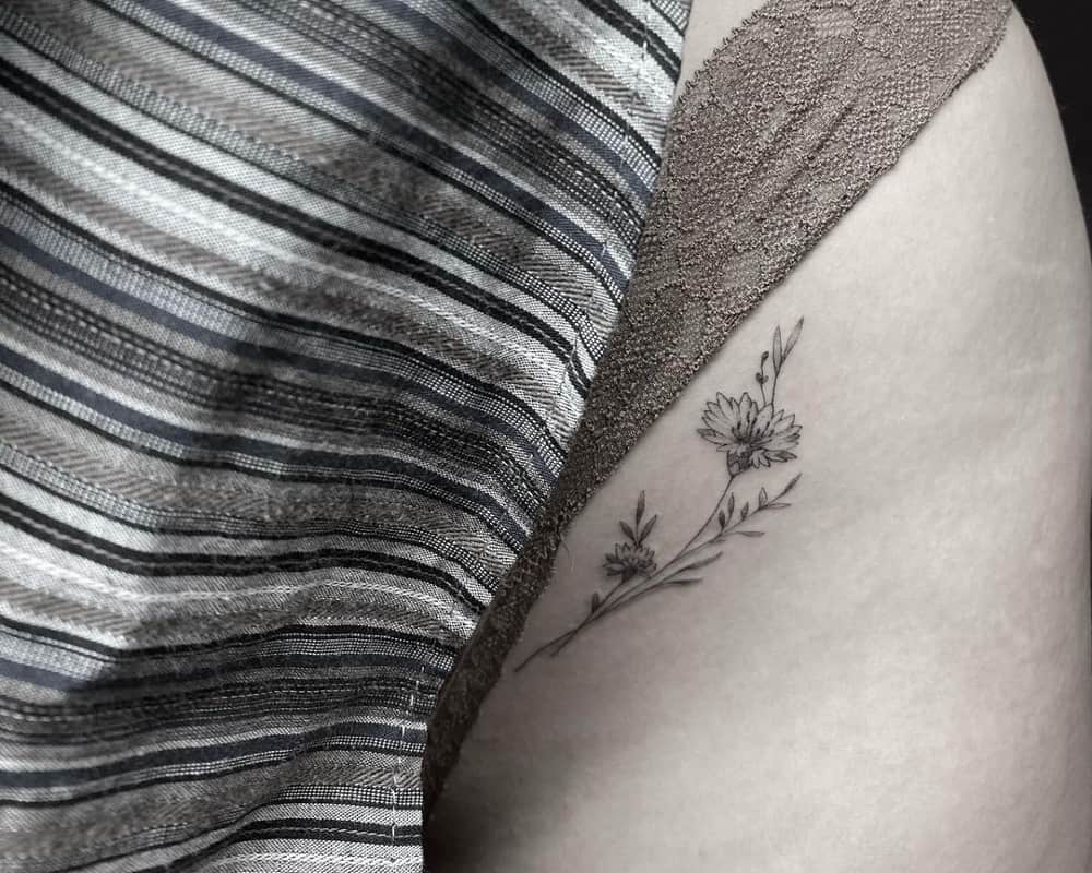 tattoo of a delicate branch of flowers