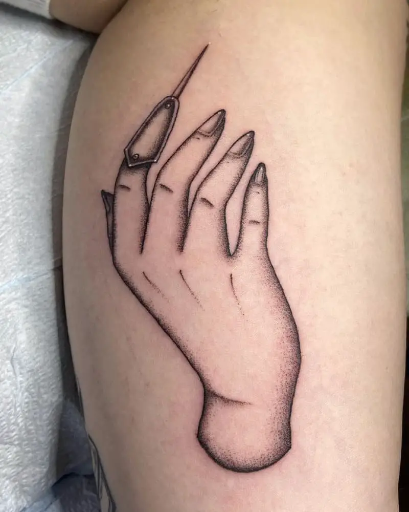 tattoo of a hand with a thimble