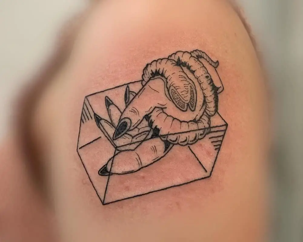 tattoo of a hand wrapped in a sandworm