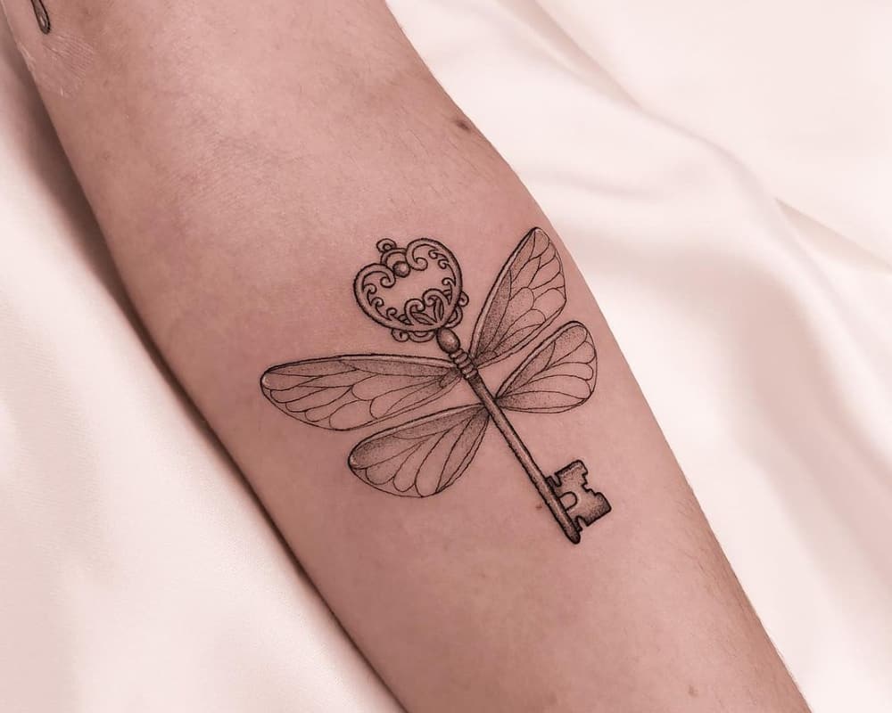 tattoo of a key with wings