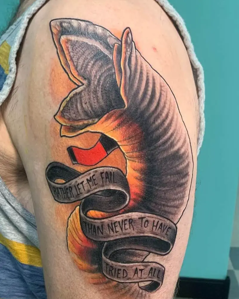 tattoo of a large sandworm and the inscription rather let me fail than never to have tried at all