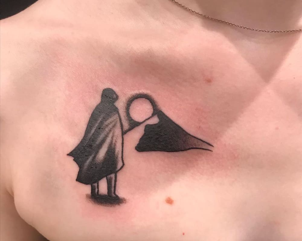 tattoo of a man in a cloak on the desert background