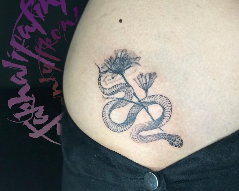 tattoo of a snake with a branch of a flower