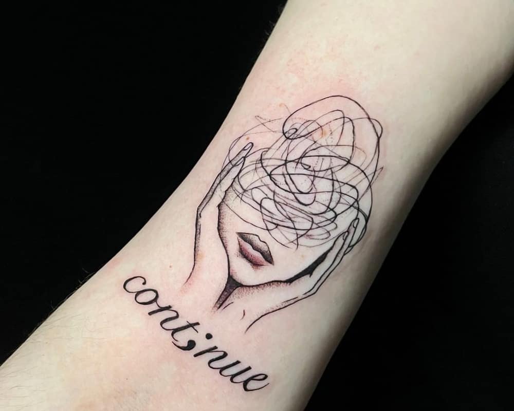 tattoo of a woman's face with confused thoughts and the inscription continue