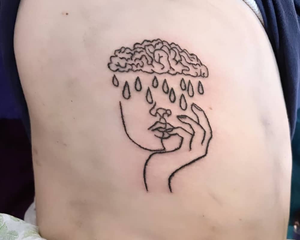 tattoo of a woman's head with a rainy cloud