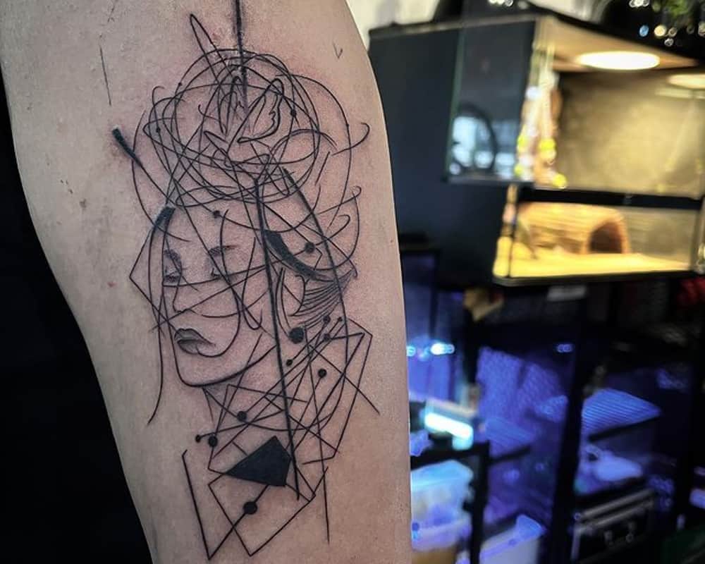 tattoo of an abstract portrait in intricate lines