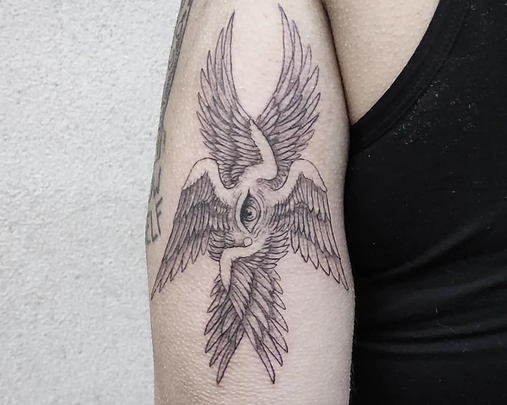tattoo of an angel with six wings and an eye