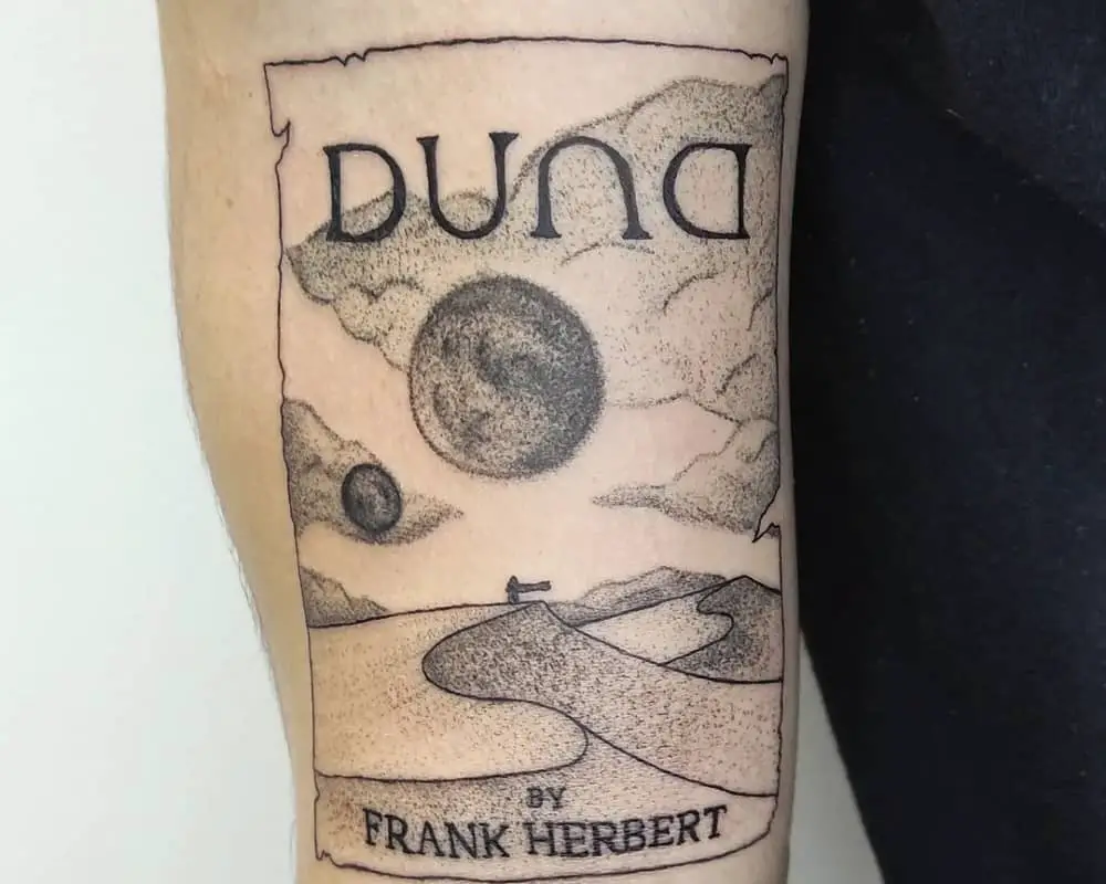 tattoo of desert with the inscription Duna by Frank Herbert