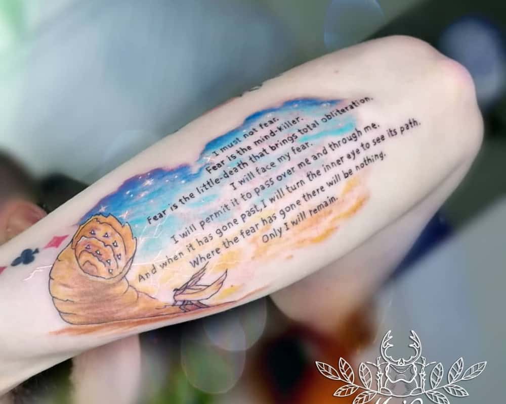 tattoo of the desert and a quote from the book