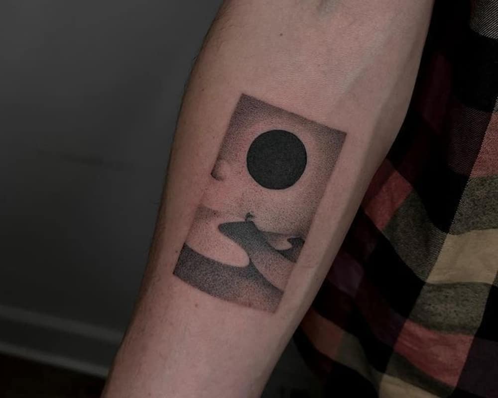 tattoo of the desert with the black sun