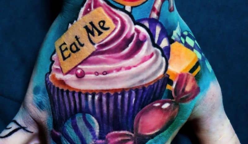 Сandies and cupcake with "Eat me" tattoo