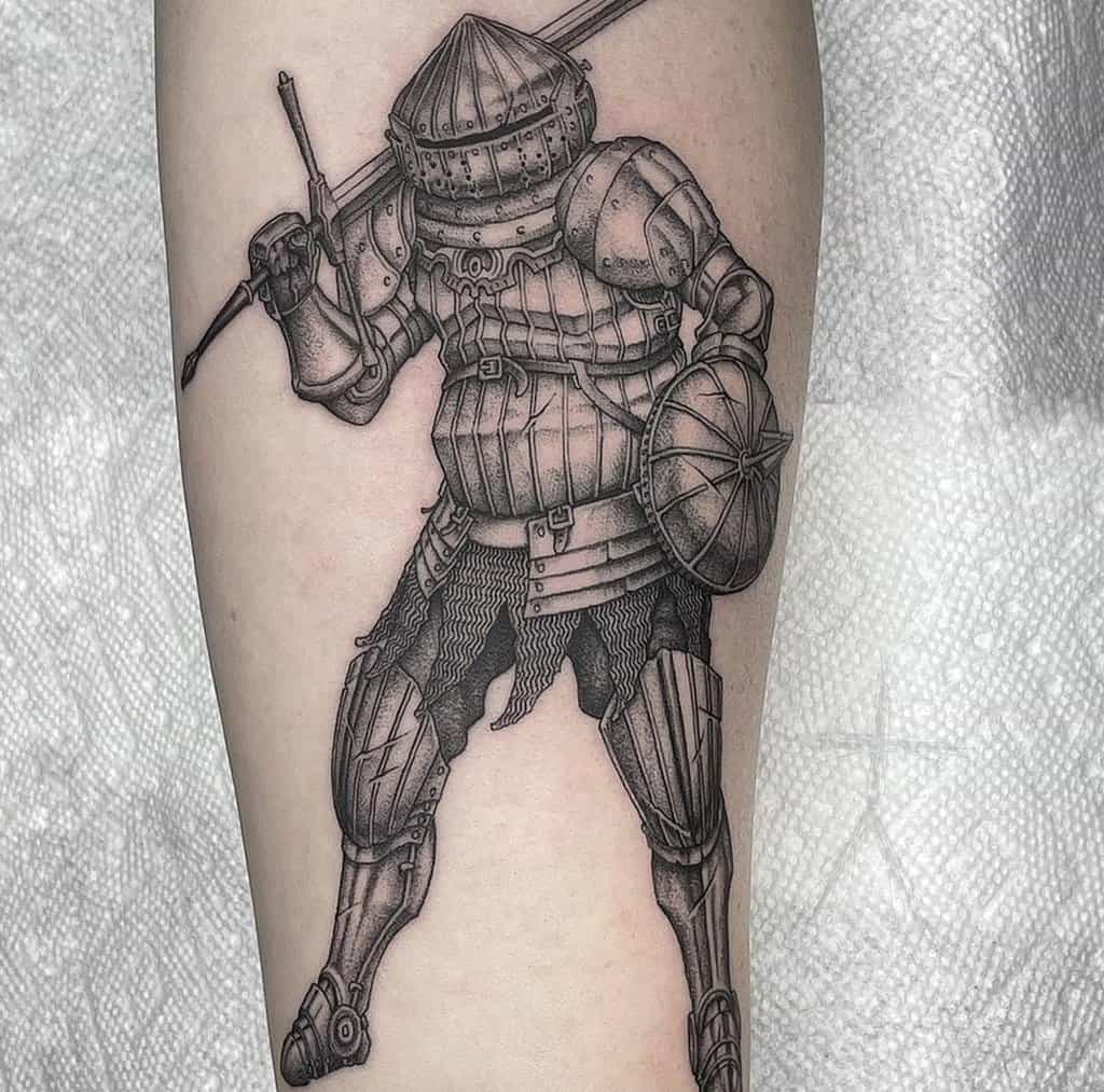A tattoo of a knight with a sword on his shoulder