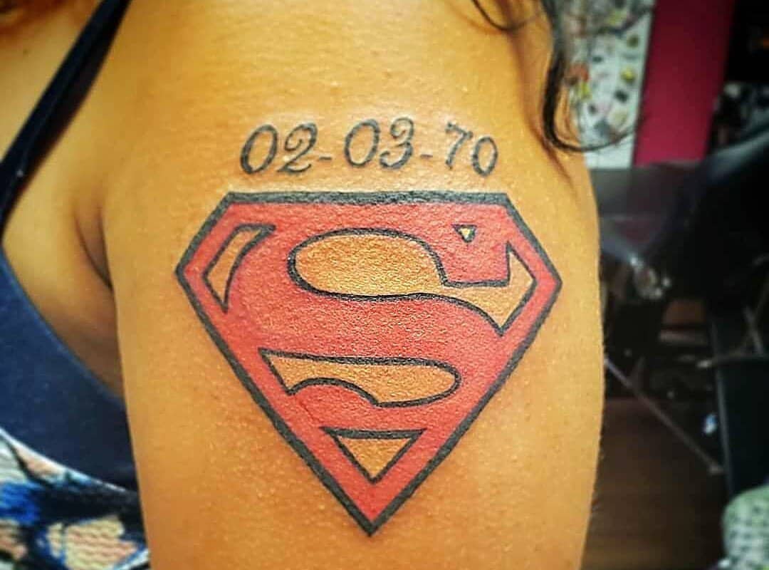 Superman emblem tattoo with the date