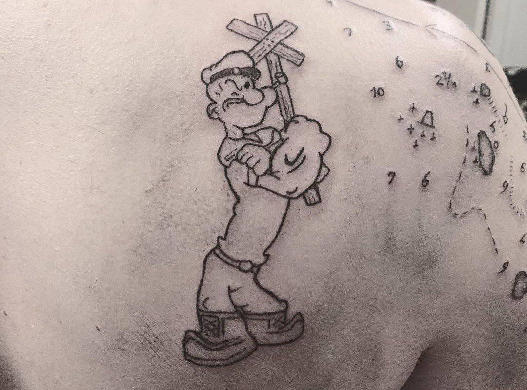 black and white Popeye sailor tattoo on the back