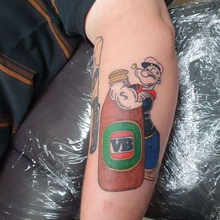 A tattoo of a Popeye sailor hugging a bottle