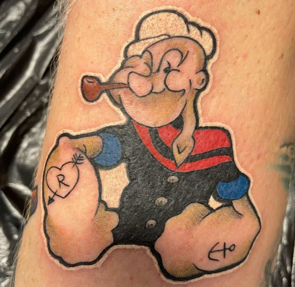 small colored tattoo of a sailor with his hands resting on his side