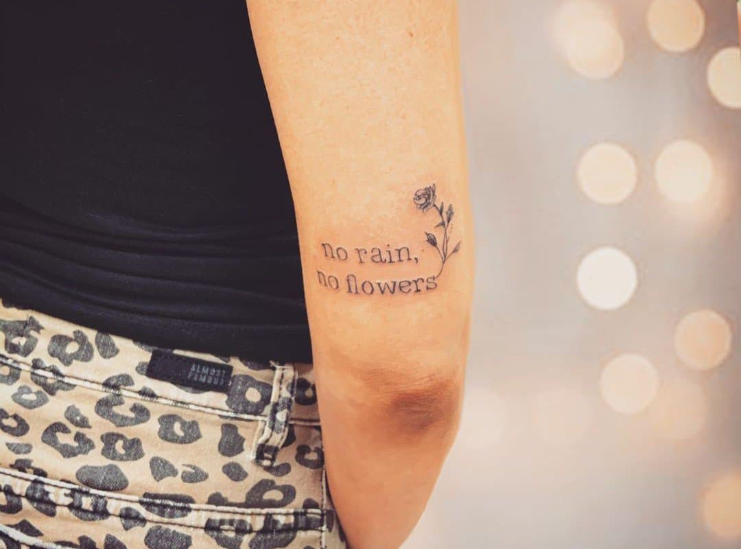 "no rain no flowers tattoo" near the elbow