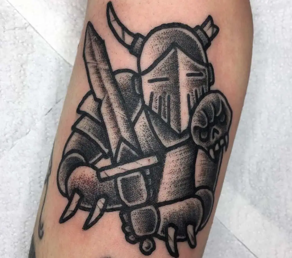 A tattoo of a knight with a sword and a helmet with horns