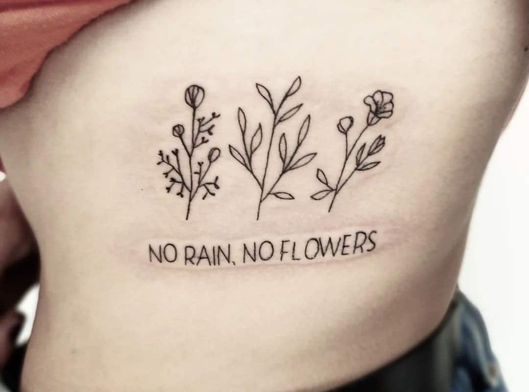 "no rain no flowers" tattoo close-up