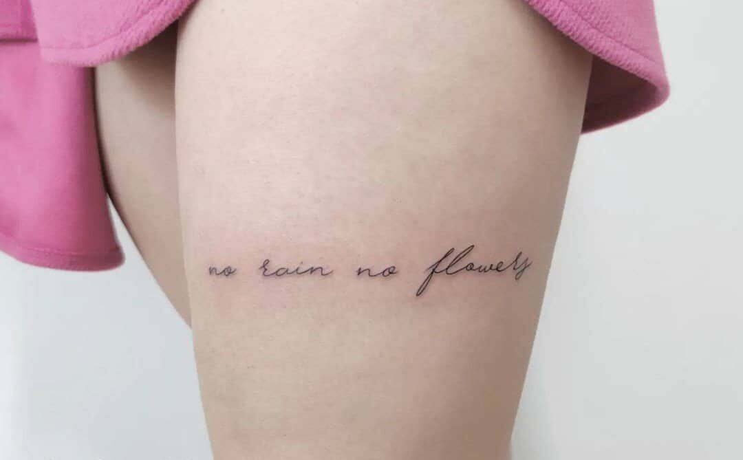 a small "no rain no flower" tattoo on my leg