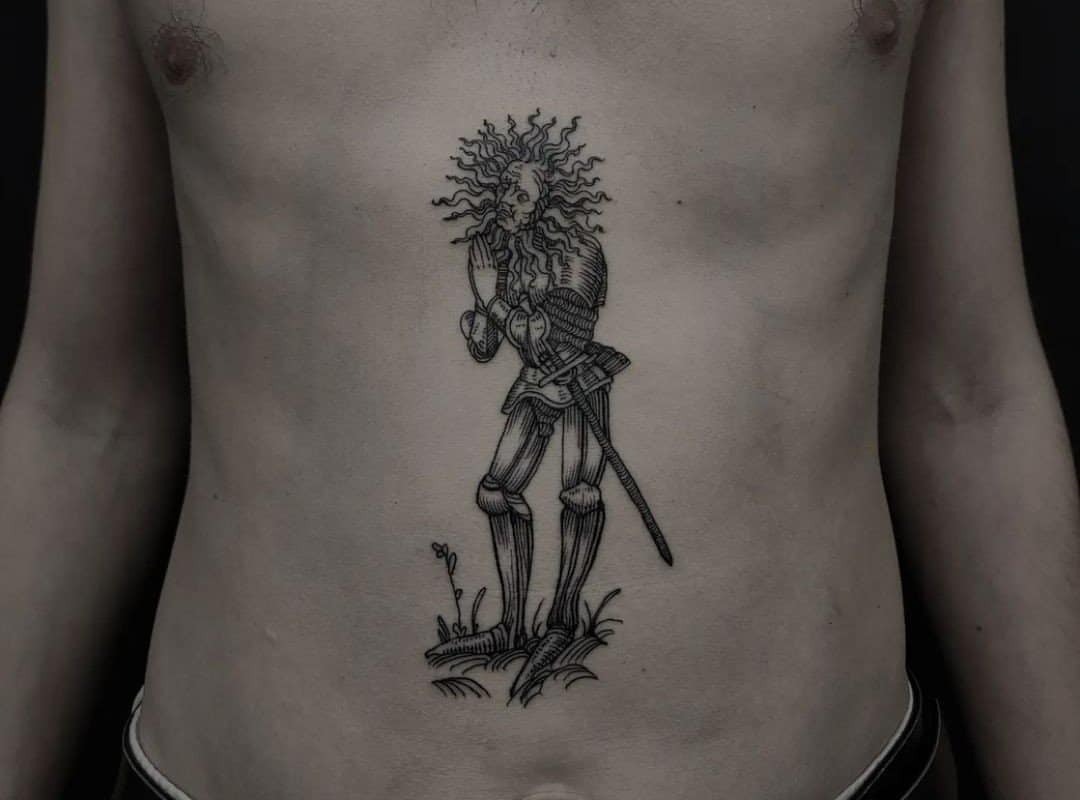 Tattoo of a knight on a man's stomach