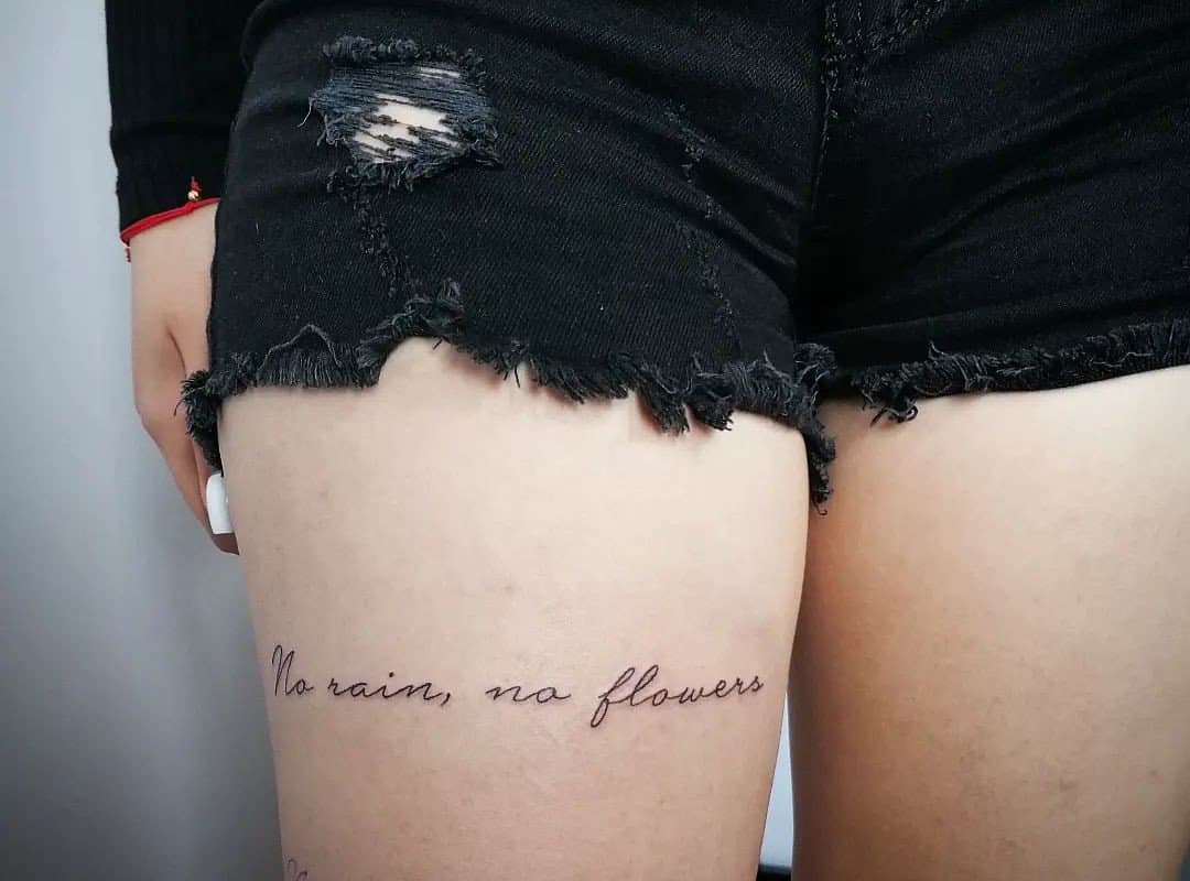 "no rain no flowers" tattoo on thigh