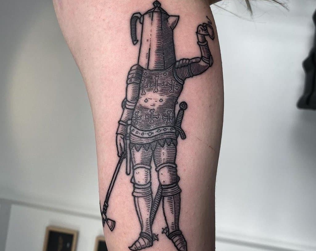 A tattoo of a knight with a teapot instead of a head