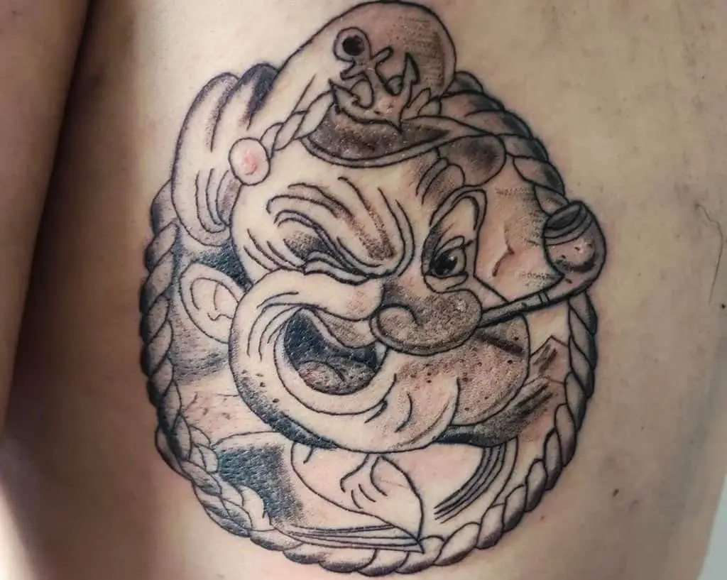 A tattoo of a smiling sailor Popeye