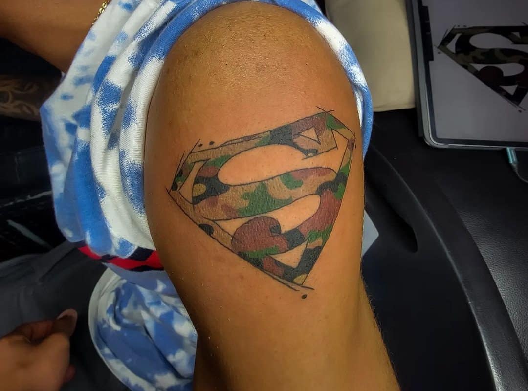 Superman logo tattooed on the shoulder