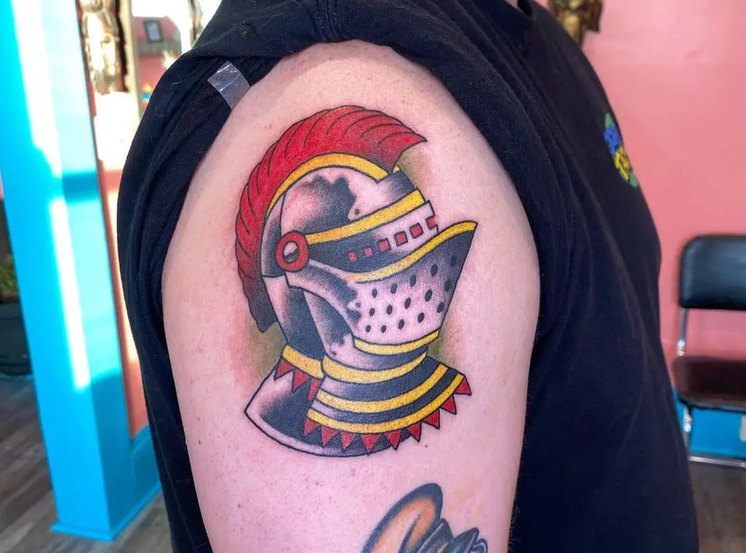 Tattoo of a knight's helmet with a red eroke