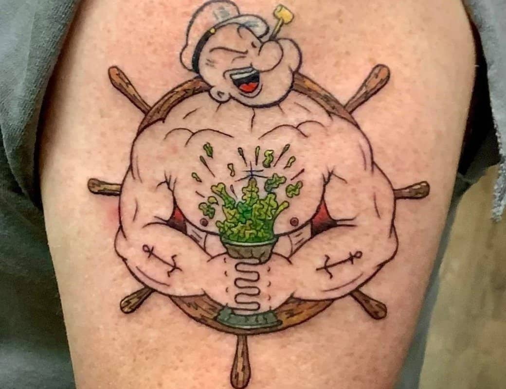Popeye sailor tattoo with a helm in the background