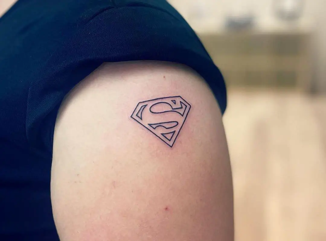 a small superman emblem tattooed on his shoulder