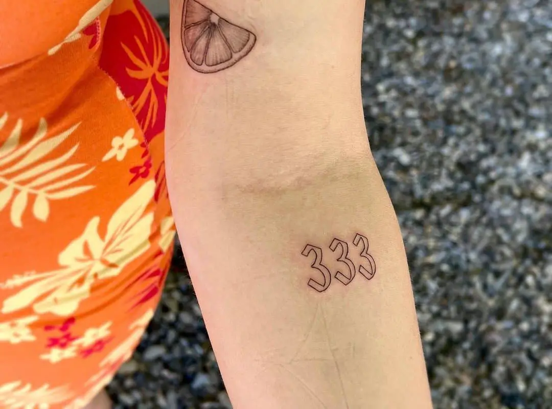 The number 333 tattooed on the forearm