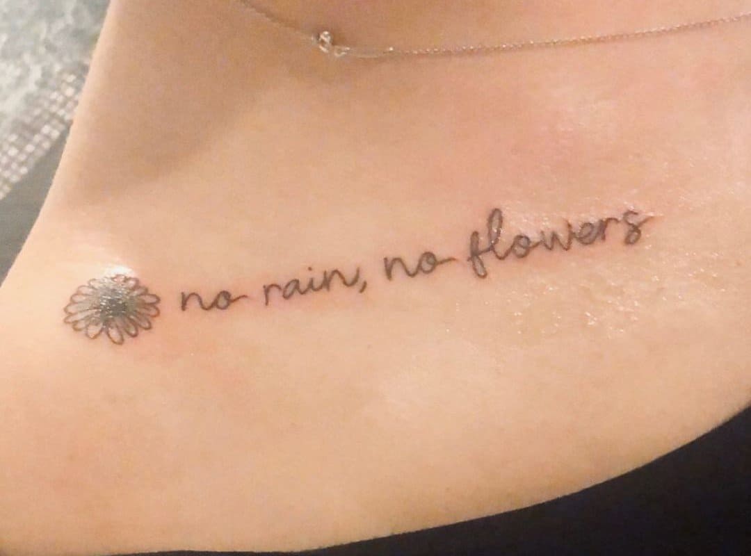 "no rain no flowers" tattoo on collarbone