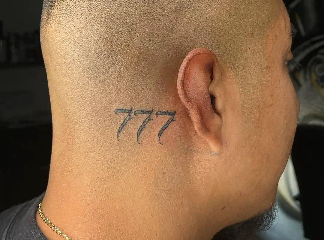 777 tattoo behind a man's ear