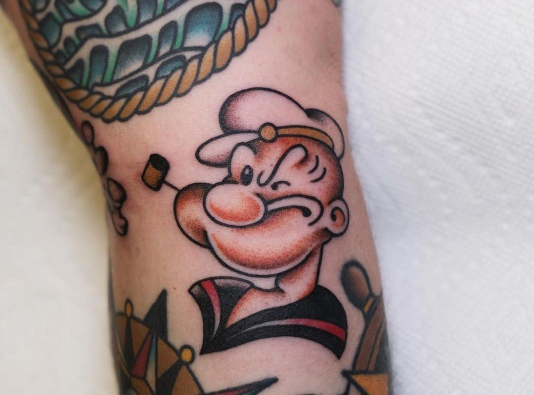 colored tattoo of a Popeye sailor's head with a snorkel