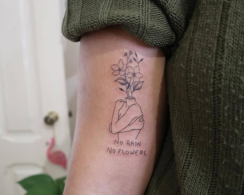 "no rain no flowers" tattoo on bicep