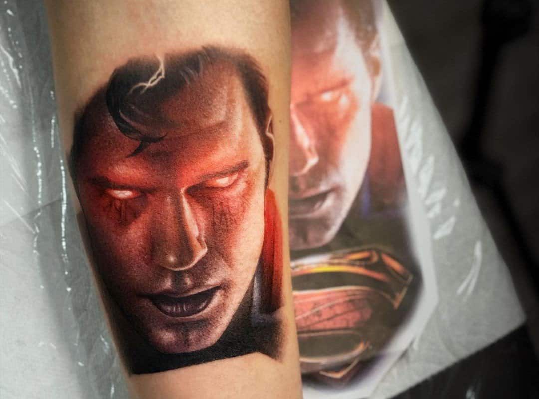 superman tattoo with red eyes