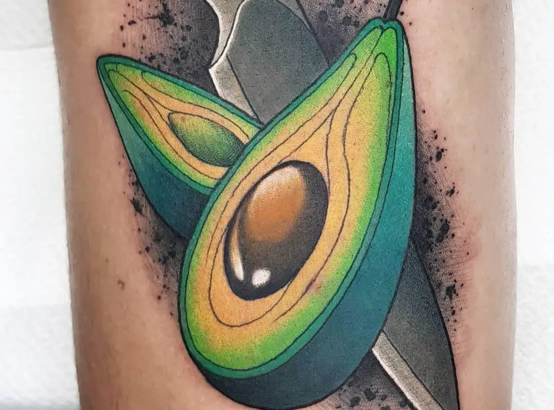 a tattoo of an avocado cut in half 