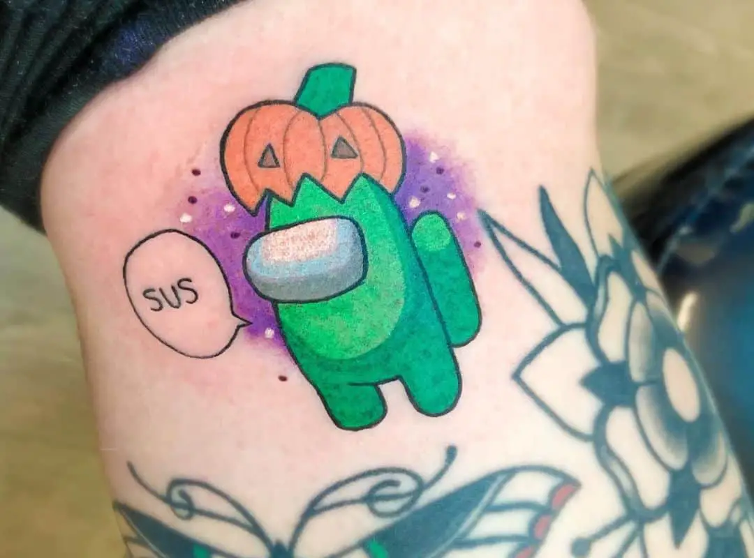 Green crewmate in a pumpkin hat tattoo