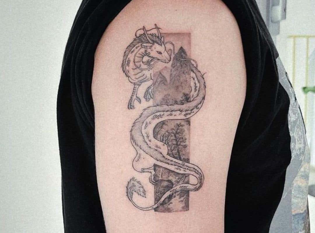 Black and white Haku dragon with mountains tattoo