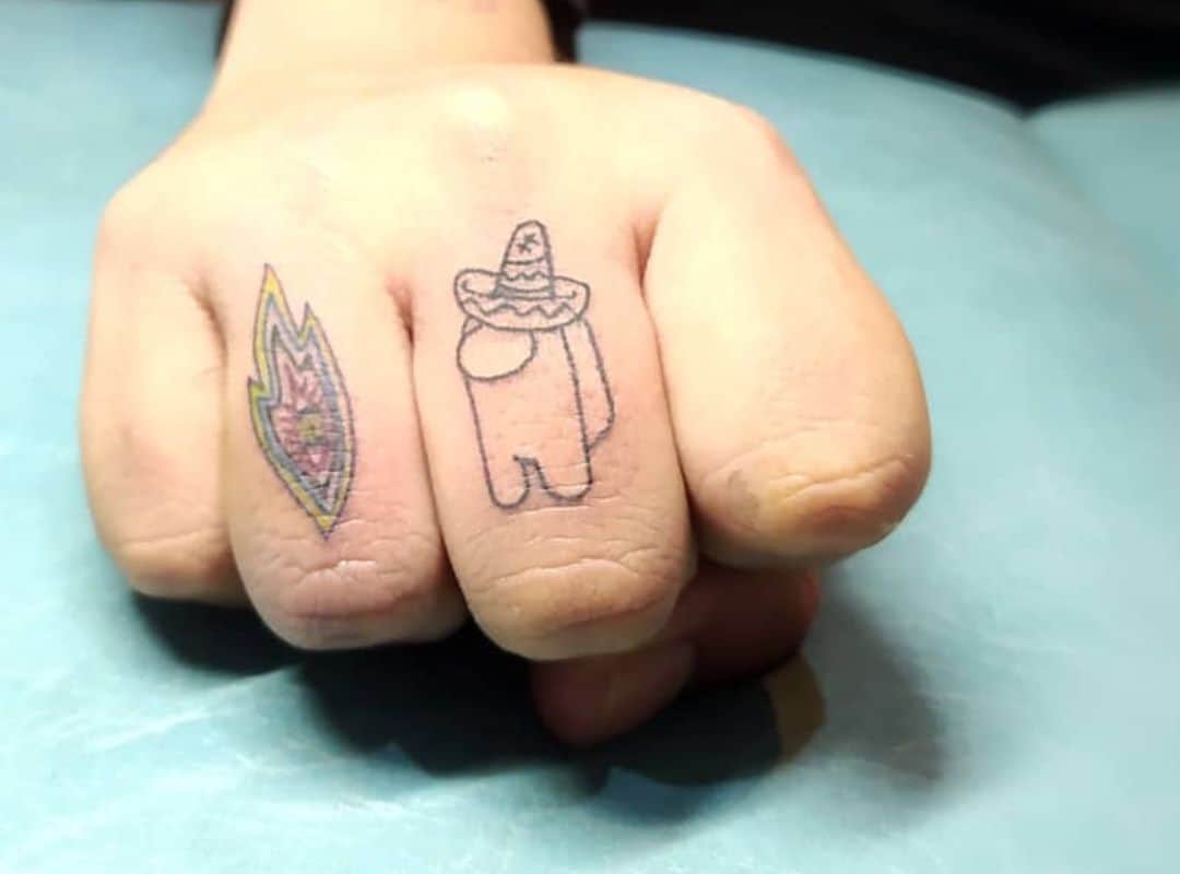 Outline crewmate finger tattoo