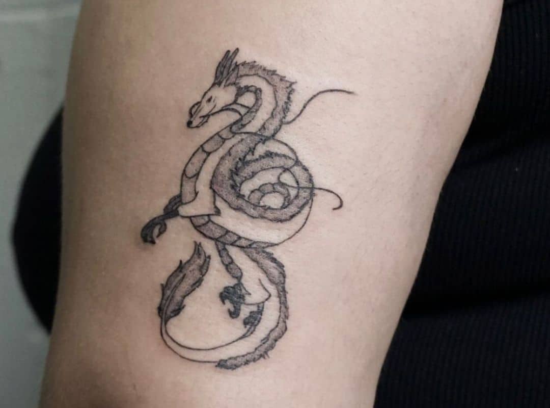 Outline Haku tattoo near the elbow