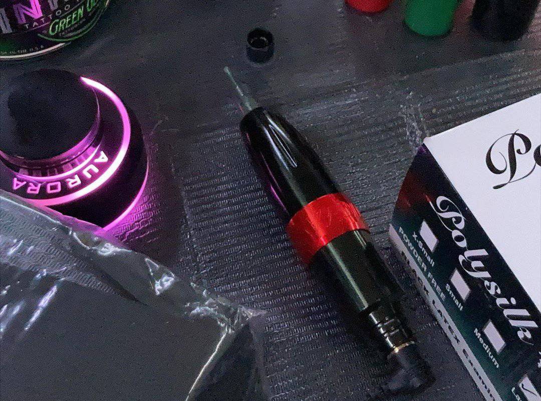 Stigma Tattoo Pen lies on the black table