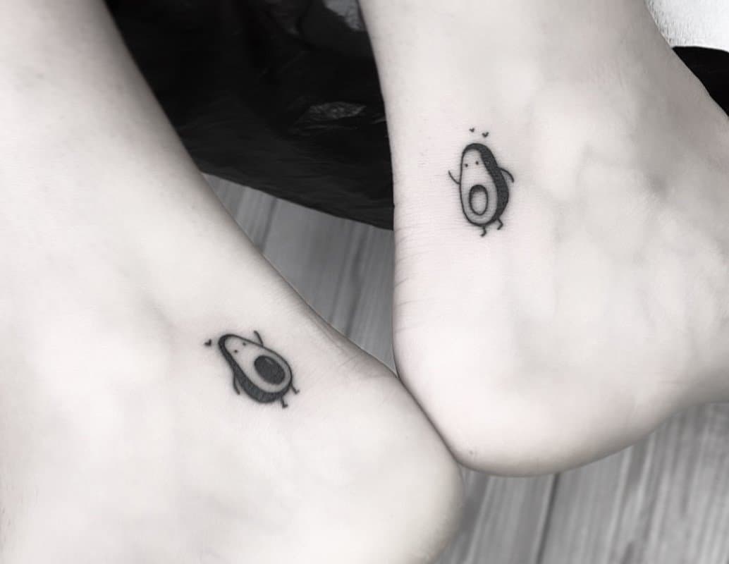 Black and white photo of a paired avocado tattoo